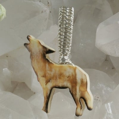 Carved bone wolf pendant