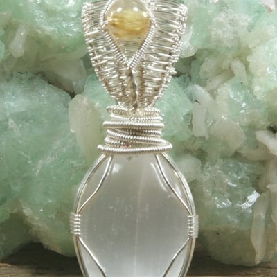 Selenite with rutilated quartz pendant