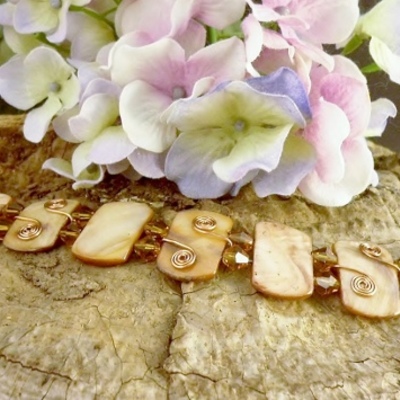Orange mother of pearl, crystal, and copper bracelet
