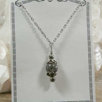 Tourmalated quartz and pyrite pendant on silver chain