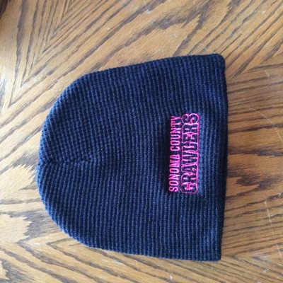Black skull cap beanie pink writing 