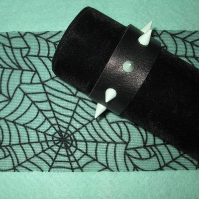 Black leather bracelet with mint green spikes