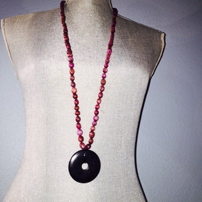 Long purple beads with black stone pendant