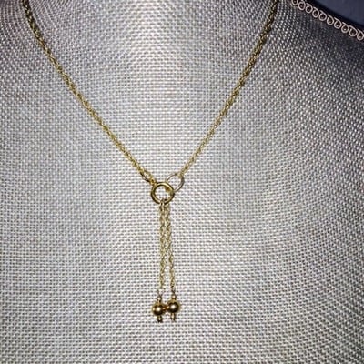 Gold rope chain with dangling pendant