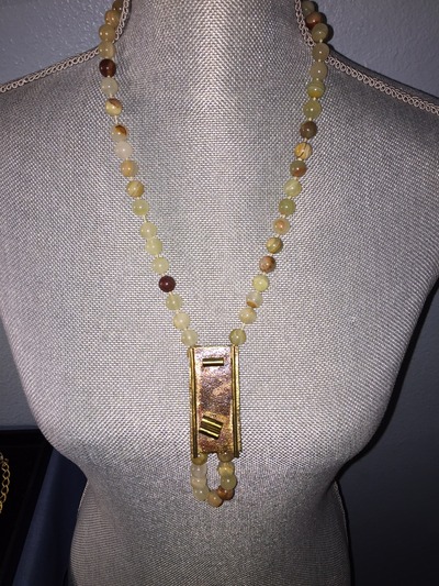 Bead necklace with signed unique pendant