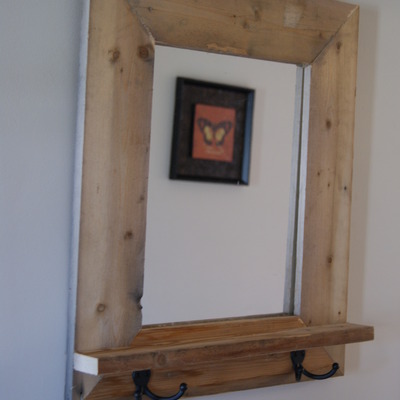 Reclaimed framed mirror with shelf.  2 bronzed key holders.  rustic frame