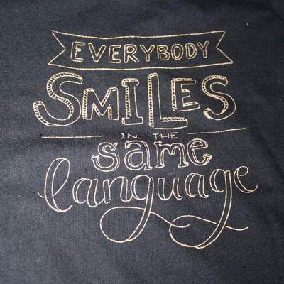 Adult everybody smiles in the same language t-shirt