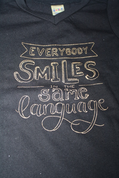Adult Everybody Smiles in the Same Language T-shirt