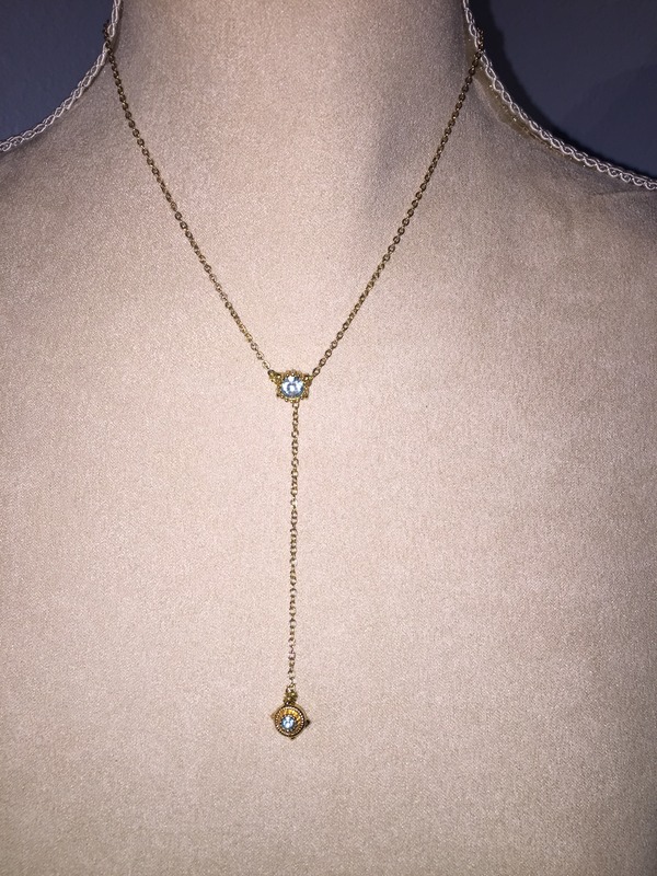 Gold Y chain with blue topaz balancing the piece