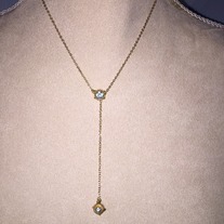 Gold Y chain with blue topaz balancing the piece
