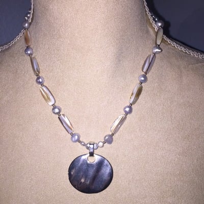 Shell beads with silver pendant