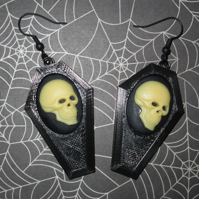 Small black coffin earrings with off-white and black skull cameos 