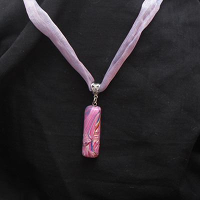 Swirly pendant ribbon necklace