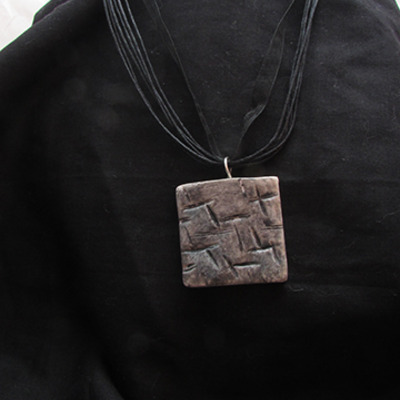 Textured silver pendant ribbon/cord necklace