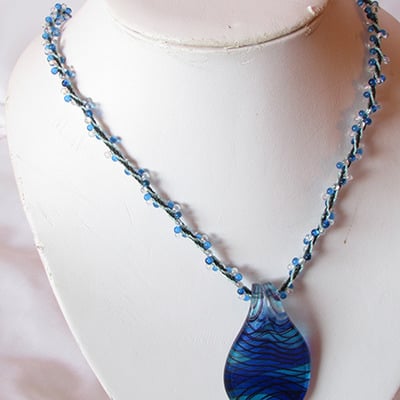 Lampwork pendant on kumihimo necklace