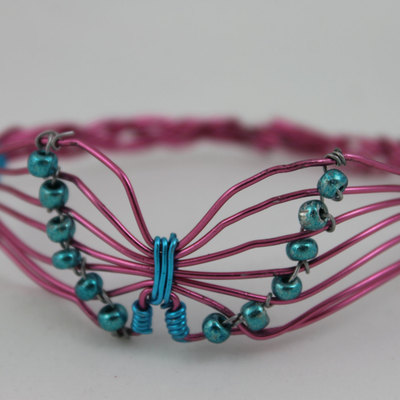 Pink wire butterfly bracelet with teal beads