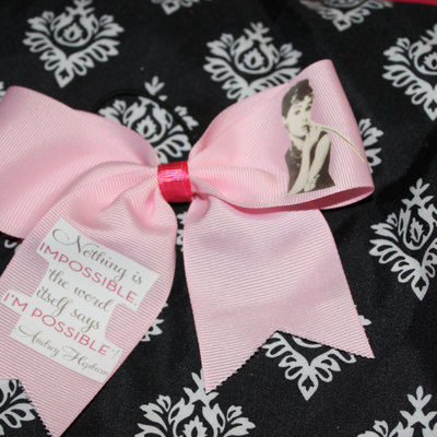 "audrey hepburn;nothing is impossible" quote cheer bow; 2 in pale pink grosgrain ribbon with hot pink center 
