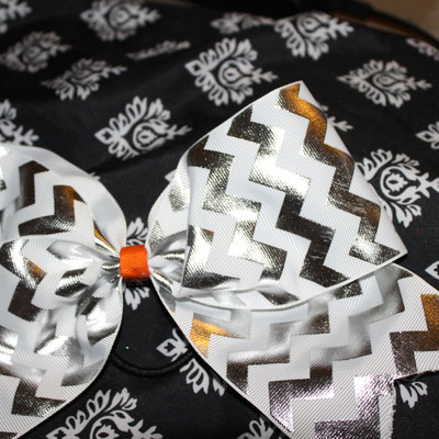 3 in silver foil, white chevron grosgrain ribbon with an orange & white polka dot center cheer bow