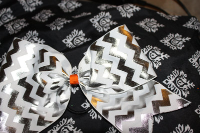 3 in Silver Foil, White Chevron Grosgrain Ribbon with an Orange & White Polka Dot center Cheer Bow