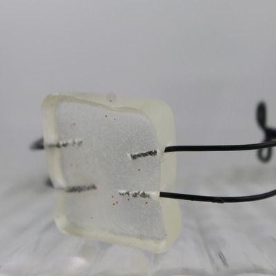 "hannah" in clear resin and black wire 