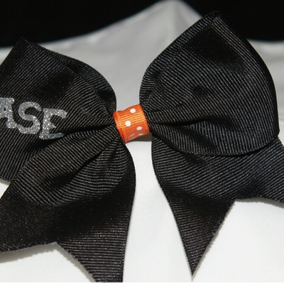 Stunt group bows - "base" 2 in black grosgrain ribbon with an orange & white polka dots center; silver bling letters cheer bow