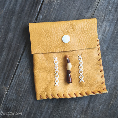 Mustard leather with brown beads and stitching