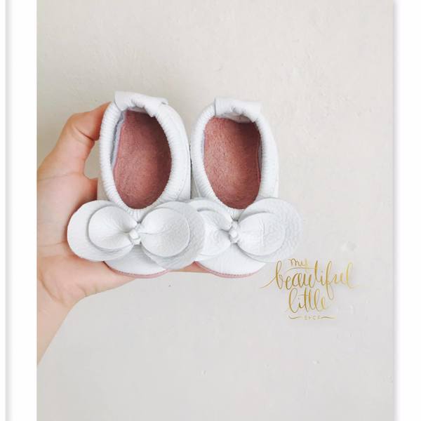 White  flats with bow and pink soles