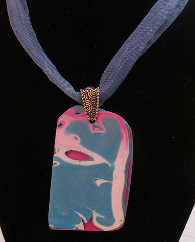Layered teal polymer clay pendant