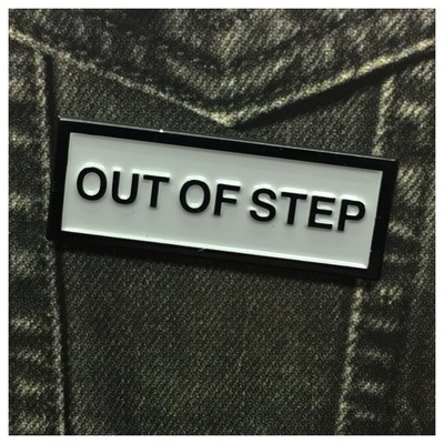 Out of step enamel pin 104
