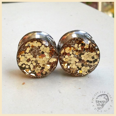 Golden glitter plugs for stretched ears