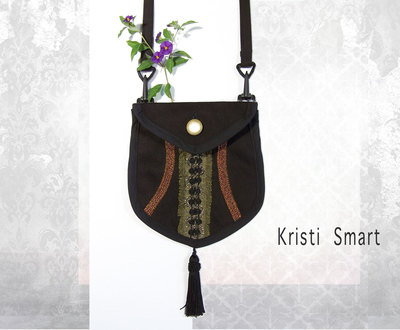 Black and bronze clip on pocket or small purse. 