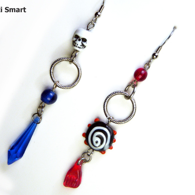 Mismatched pirate skull earrings in red and blue