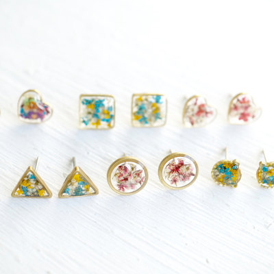 Real pressed flower and resin stud earrings in reds, oranges, blues, purples, and pinks mix