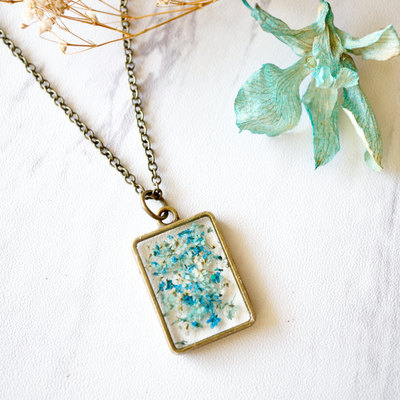 Real pressed flower and resin necklace in teal mint blue mix