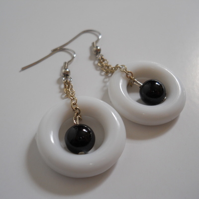 White ring and black bead earrings