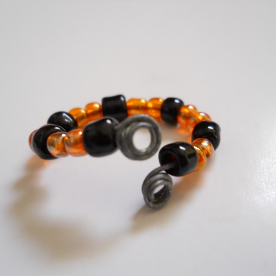 Orange and black wire bead ring