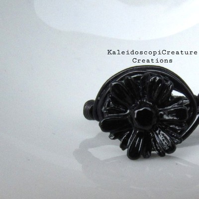Black on black on black daisy ring