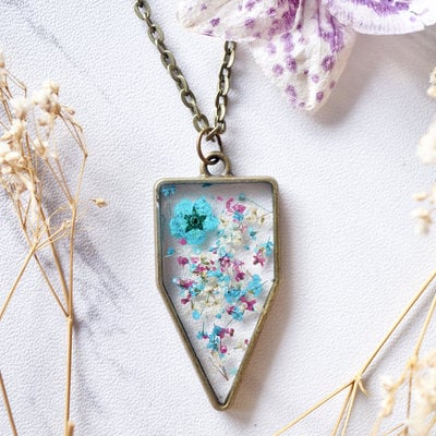 Real dried flowers in resin necklace, arrowhead in teal magenta white