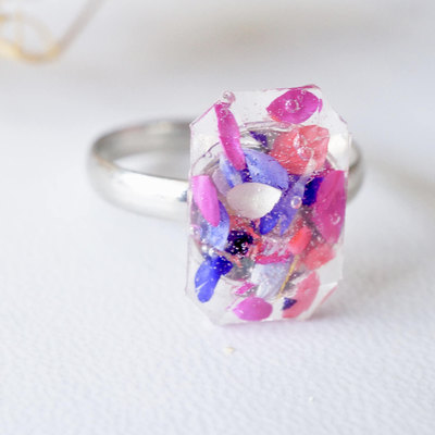 Real pressed flower and resin ring in reds, purples, pinks, and white
