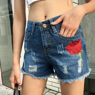 Rose embroidered ripped denim shorts