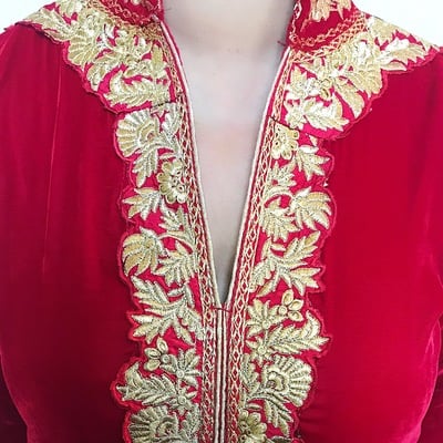 Red velvet suit with gold threadwork details