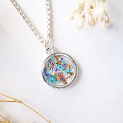 Real dried flowers in resin necklace, small silver circle in orange purple blue
