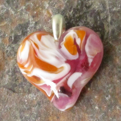 Salmon pink and cinnabar glass heart pendant