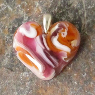 Salmon pink and cinnabar glass heart pendant
