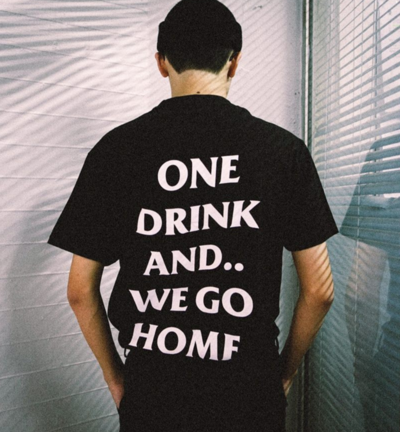 ONE DRINK AND WE GO HOME T SHIRT IN BLACK ( WHITE TEXT )