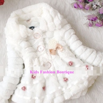 Girls white fur coat adorned with beautiful flowers.
