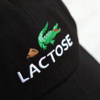 LACOSTE SPOOF CROCODILE POOP CAP IN BLACK - Thumbnail 1
