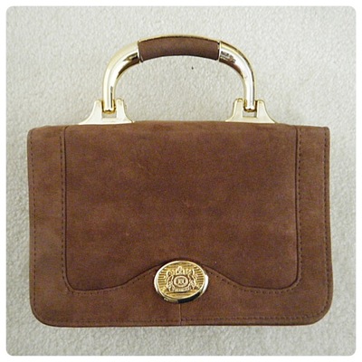 Brown bag with gold details and detachable strap