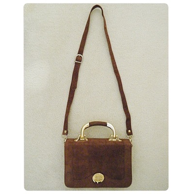 Brown bag with gold details and detachable strap
