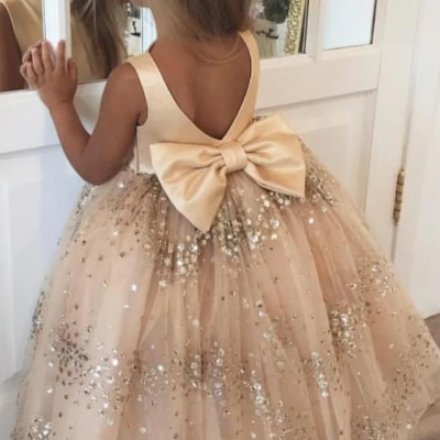Lovely sparkly champagne long flower girl dress with bow on the back